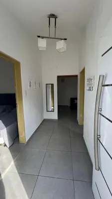 an empty room with a hallway with a bed at MIGUEL JUAREZ 47 in Villa Carlos Paz