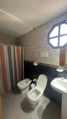 a bathroom with a toilet and a sink at MIGUEL JUAREZ 47 in Villa Carlos Paz
