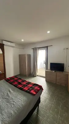 a bedroom with a bed and a television in it at MIGUEL JUAREZ 47 in Villa Carlos Paz