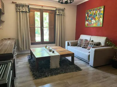 a living room with a couch and a coffee table at Casa con pileta en las sierras in La Calera