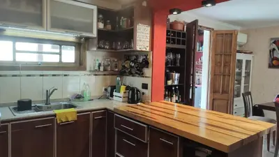 a kitchen with a wooden counter top in a room at Casa con pileta en las sierras in La Calera
