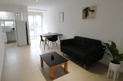 a living room with a black couch and a table at Hermosa Vista 2 in Cordoba