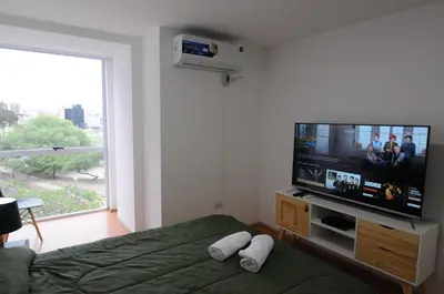 a bedroom with a flat screen tv and a bed at Hermosa Vista 2 in Cordoba