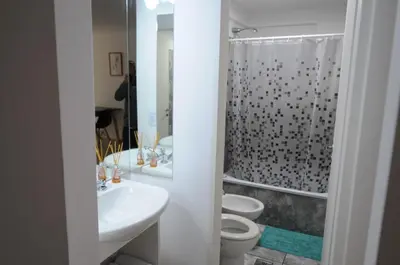 a white bathroom with two toilets and a shower at Hermosa Vista 2 in Cordoba