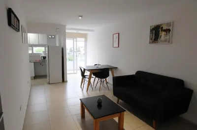 a living room with a black couch and a table at Hermosa Vista 2 in Cordoba