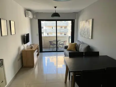 a living room with a couch and a table at Departamento equipado ideal para 4 en Nueva Córdoba in Cordoba