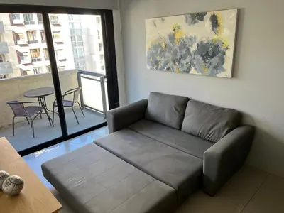 a living room with a couch and a table at Departamento equipado ideal para 4 en Nueva Córdoba in Cordoba