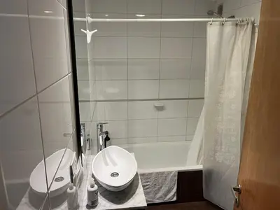 a white bathroom with a sink and a shower at Departamento equipado ideal para 4 en Nueva Córdoba in Cordoba