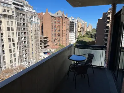 a balcony with two chairs and a table on a balcony at Departamento equipado ideal para 4 en Nueva Córdoba in Cordoba
