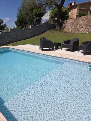 a swimming pool with two chairs and a table at Hermosa casa 351-6 en villa 157 carlos paz 157 - SOLO FAMILIAS in Villa Carlos Paz