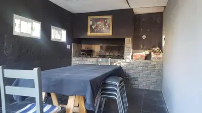 a dining room with a table and a fireplace at Hermosa casa 351-6 en villa 157 carlos paz 157 - SOLO FAMILIAS in Villa Carlos Paz