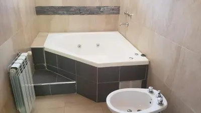 a bathroom with a tub and a toilet and a sink at Hermosa casa 351-6 en villa 157 carlos paz 157 - SOLO FAMILIAS in Villa Carlos Paz