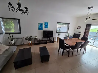 a living room with a table and a couch at Hermosa casa 351-6 en villa 157 carlos paz 157 - SOLO FAMILIAS in Villa Carlos Paz