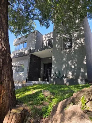 a building with a tree in front of it at Hermosa casa 351-6 en villa 157 carlos paz 157 - SOLO FAMILIAS in Villa Carlos Paz