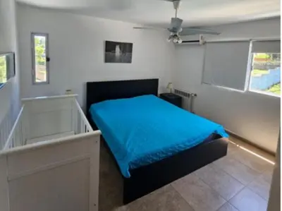 a bedroom with a bed with a blue blanket at Hermosa casa 351-6 en villa 157 carlos paz 157 - SOLO FAMILIAS in Villa Carlos Paz