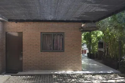 a brick building with a door and a window at Club Resort in Mina Clavero