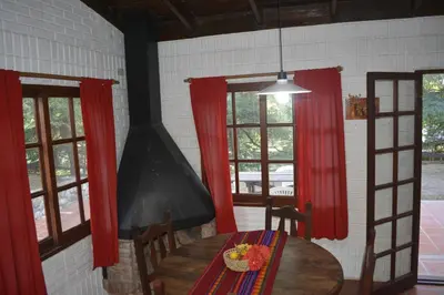 a dining room with a table and red curtains at Club Resort in Mina Clavero
