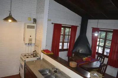 a kitchen with a sink and a stove and windows at Club Resort in Mina Clavero