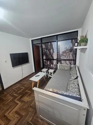 a room with a bed and a large window at Rondeau Apartamento in Cordoba