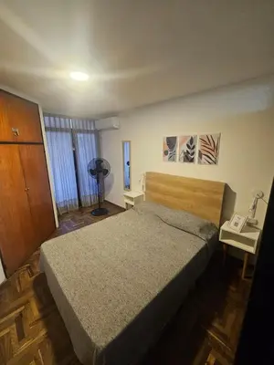 a bedroom with a bed and a telephone in it at Rondeau Apartamento in Cordoba