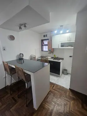 a kitchen with a table and chairs in a room at Rondeau Apartamento in Cordoba