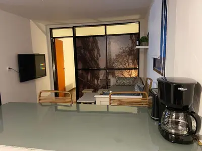 a room with a coffee maker and a window at Rondeau Apartamento in Cordoba
