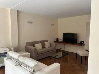 a living room with a couch and a tv at Casa Cerro de las Rosas in Cordoba