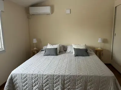 a bedroom with a large white bed with two pillows at Casa Cerro de las Rosas in Cordoba