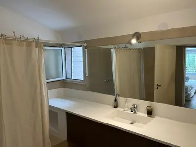 a bathroom with a sink and a large mirror at Casa Cerro de las Rosas in Cordoba