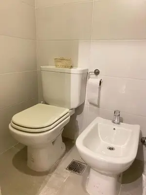 a bathroom with a white toilet and a sink at Departamento -Cata- Pleno General Paz, cerca de Sanatorios, Terminal de omnibus y Nueva Cordoba, BY Apartcba in Cordoba