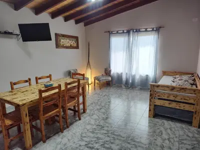 a room with a table and a bed and a table and chairs at Cabañas Alisha in Panaholma