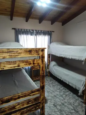 a bedroom with two bunk beds and a window at Cabañas Alisha in Panaholma