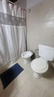 a bathroom with a toilet and a bidet at Cabaña Troncos en Los Reartes in Villa General Belgrano
