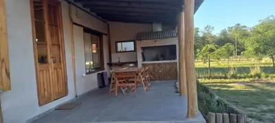 a patio with a table and chairs on a house at La adorable in Los Reartes