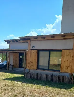 a house with a fence in front of it at La adorable in Los Reartes