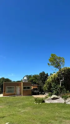 a house with a truck parked in a yard at Cabaña Concepcion del Valle in Salsacate