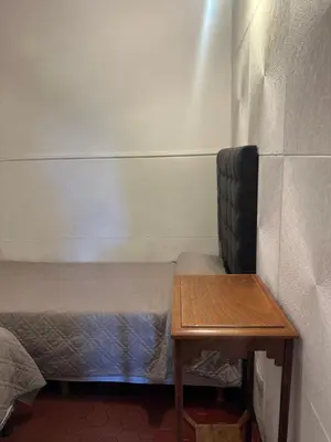 a small room with two beds and a table at lahabanadepartamento in Villa Carlos Paz