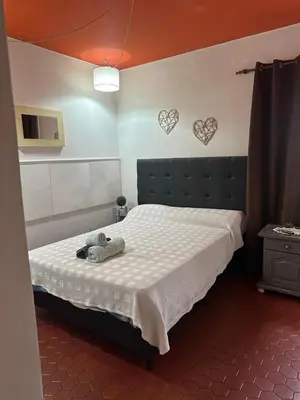 a bedroom with a bed with a teddy bear on it at lahabanadepartamento in Villa Carlos Paz