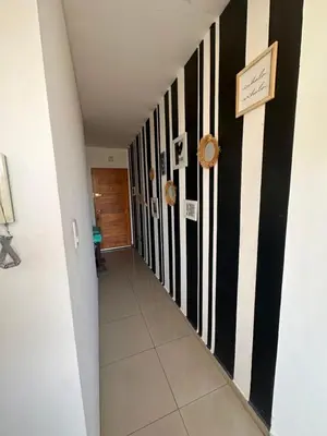 a hallway with black and white stripes on the walls at Depto Sorrento céntrico in Villa Carlos Paz