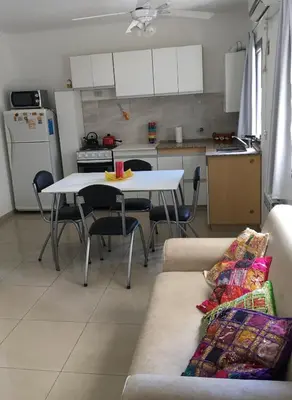 a living room with a white table and a couch at Depto Sorrento céntrico in Villa Carlos Paz