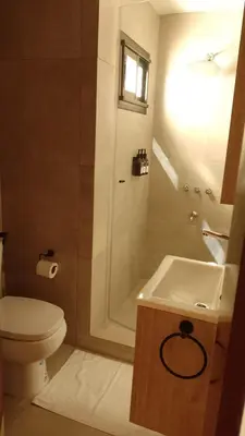 a bathroom with a toilet and a sink and a shower at Ribera Sur Hotel - Los Algarrobos - Tanti in Tanti