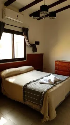 a bedroom with a bed with two towels on it at Ribera Sur Hotel - Los Algarrobos - Tanti in Tanti