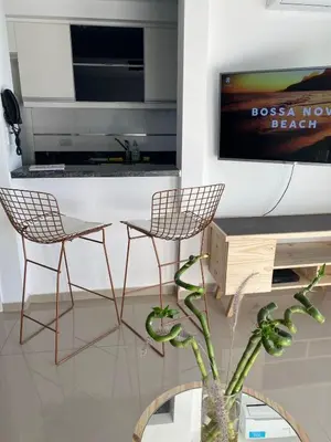 a living room with two chairs and a tv at MD Amoblado Córdoba Capital in Cordoba