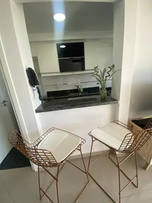 two chairs and a television in a room at MD Amoblado Córdoba Capital in Cordoba