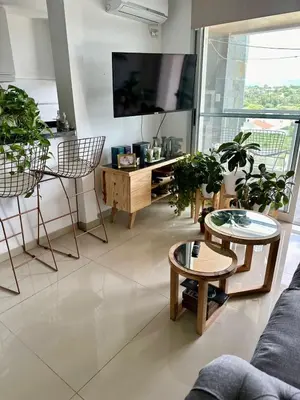a living room with potted plants and a flat screen tv at MD Amoblado Córdoba Capital in Cordoba