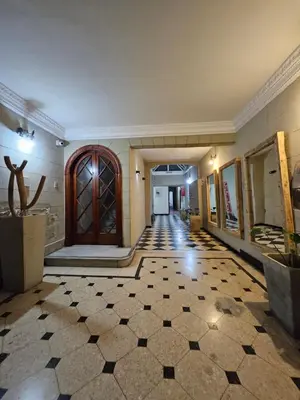 a hallway of a building with a door and a tile floor at CASONA REAL in Cordoba
