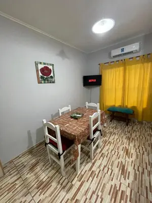 a room with a table and chairs and a yellow curtain at Santa Martina in Merlo