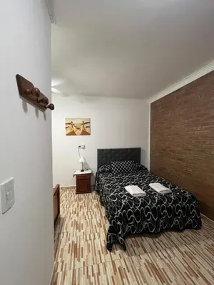 a bedroom with a bed and a brick wall at Santa Martina in Merlo