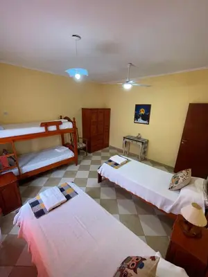 a bedroom with three beds in a room at Santa Martina in Merlo