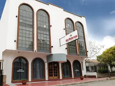 a building with large windows and a sign on it at Hotel Mediterraneo in Villa Carlos Paz